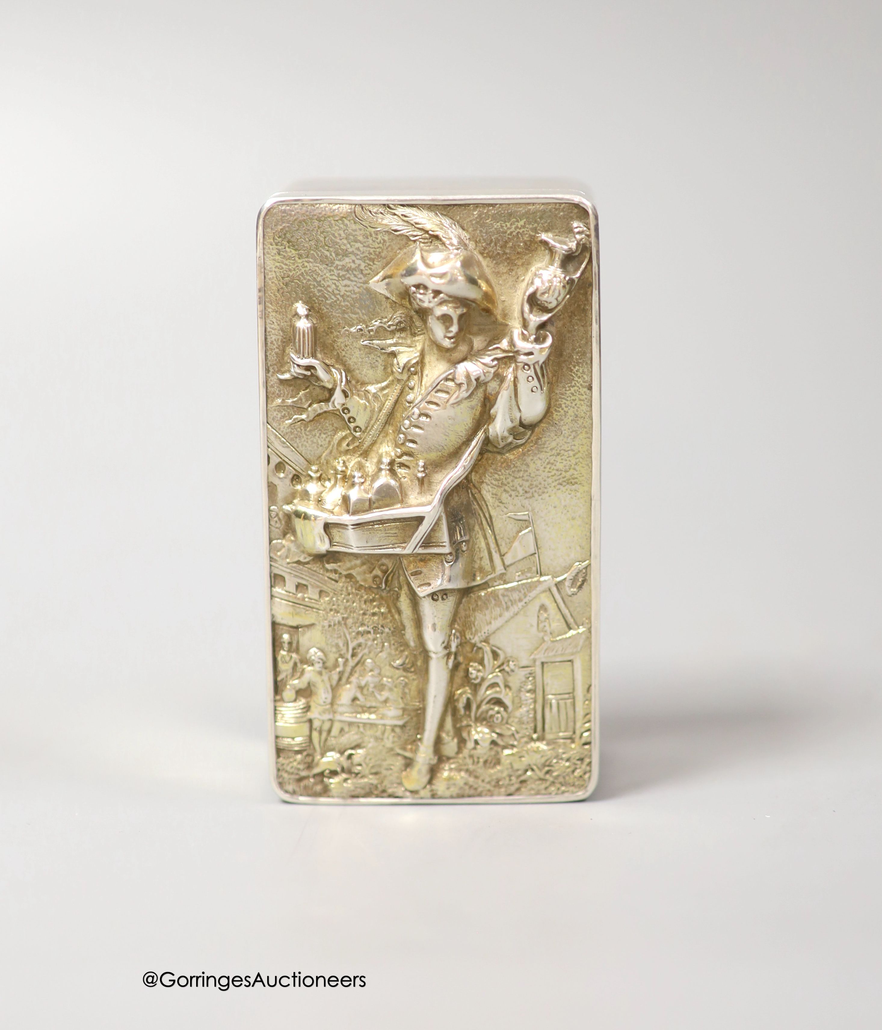 A late 19th/early 20th century continental white metal rectangular box and cover, the lid embossed with the figure of a pedlar, 9.5cm, 155 grams.